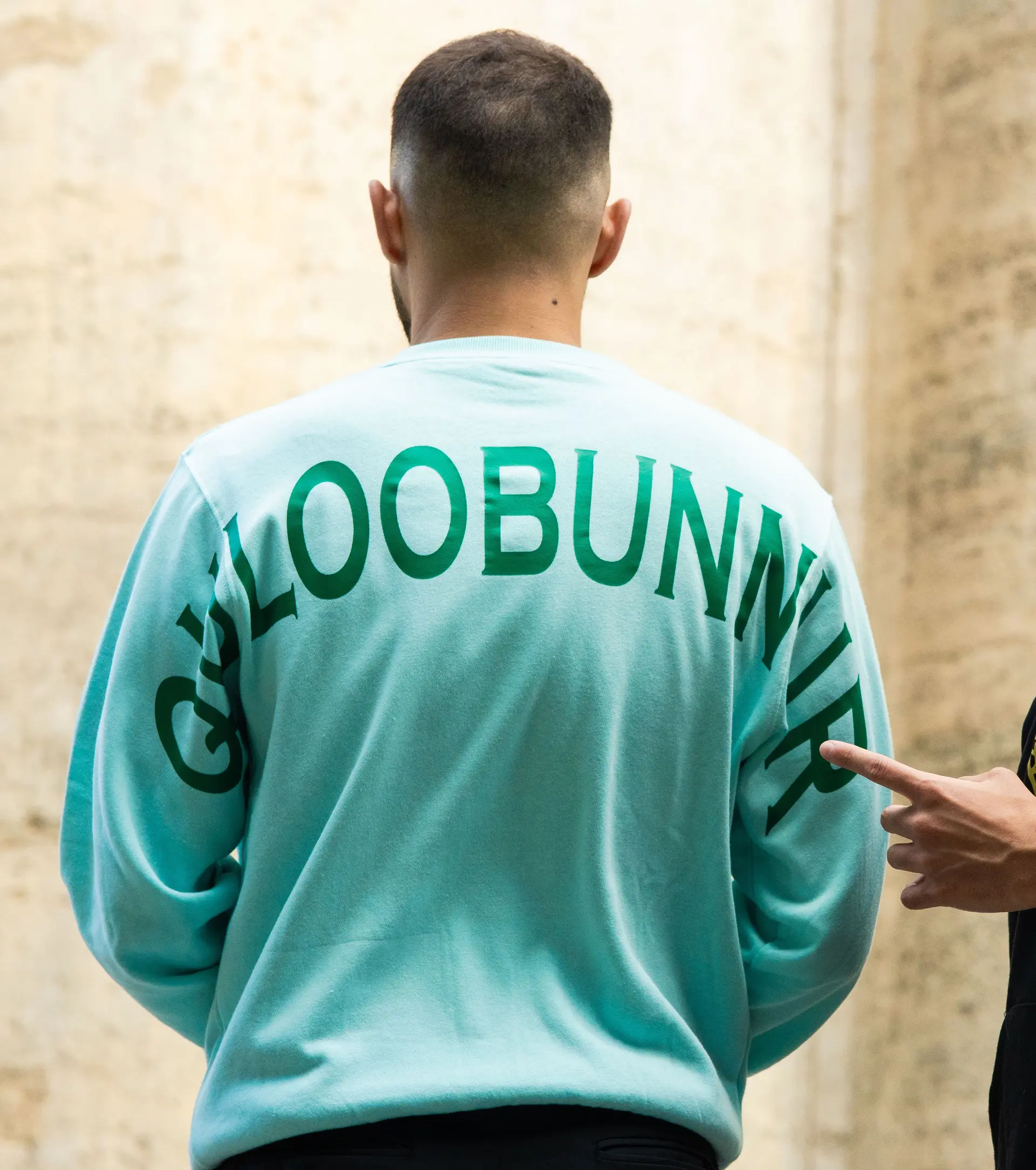 Mint crewneck from behind, name across the shoulders