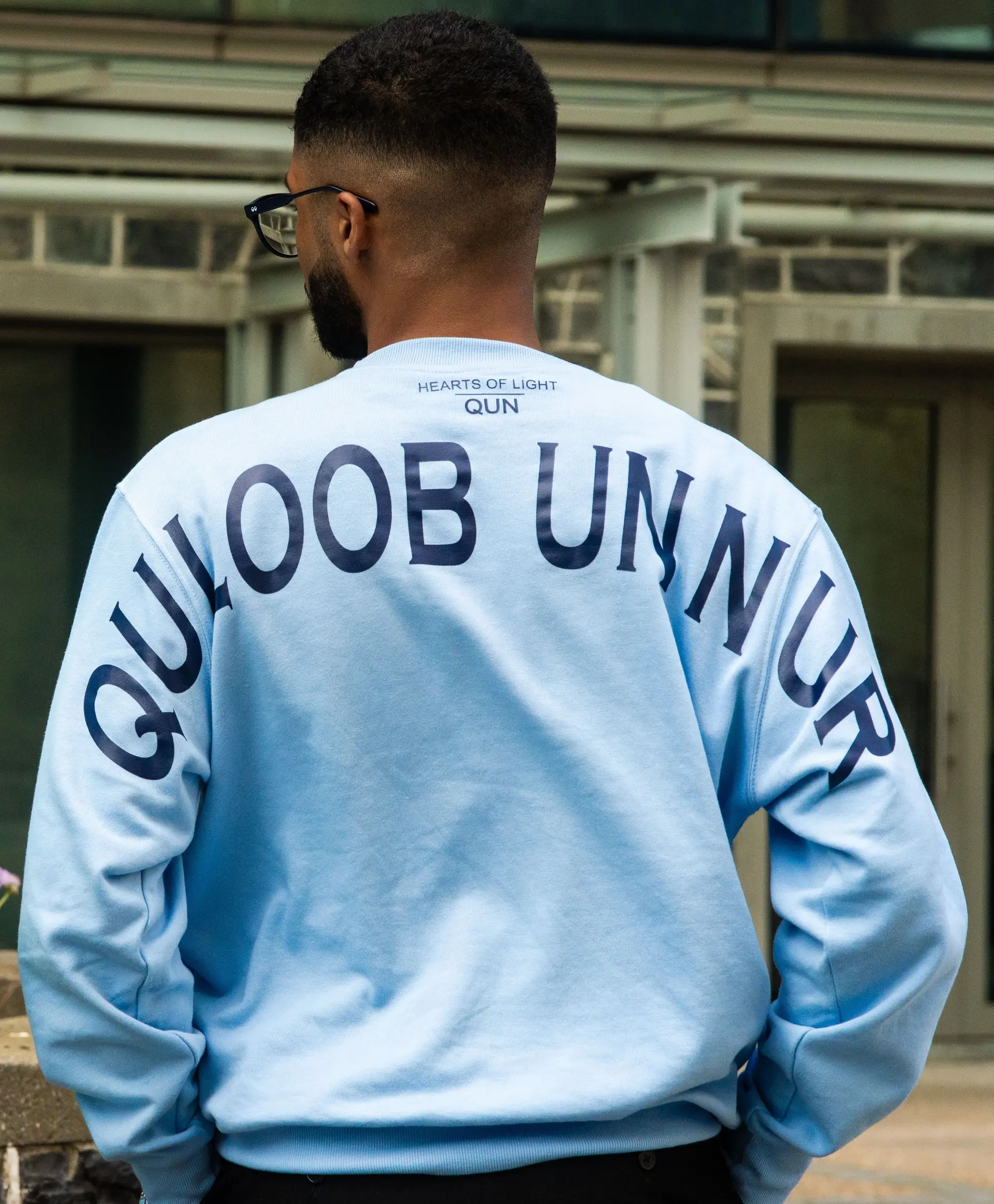 Powder blue crewneck worn outdoors