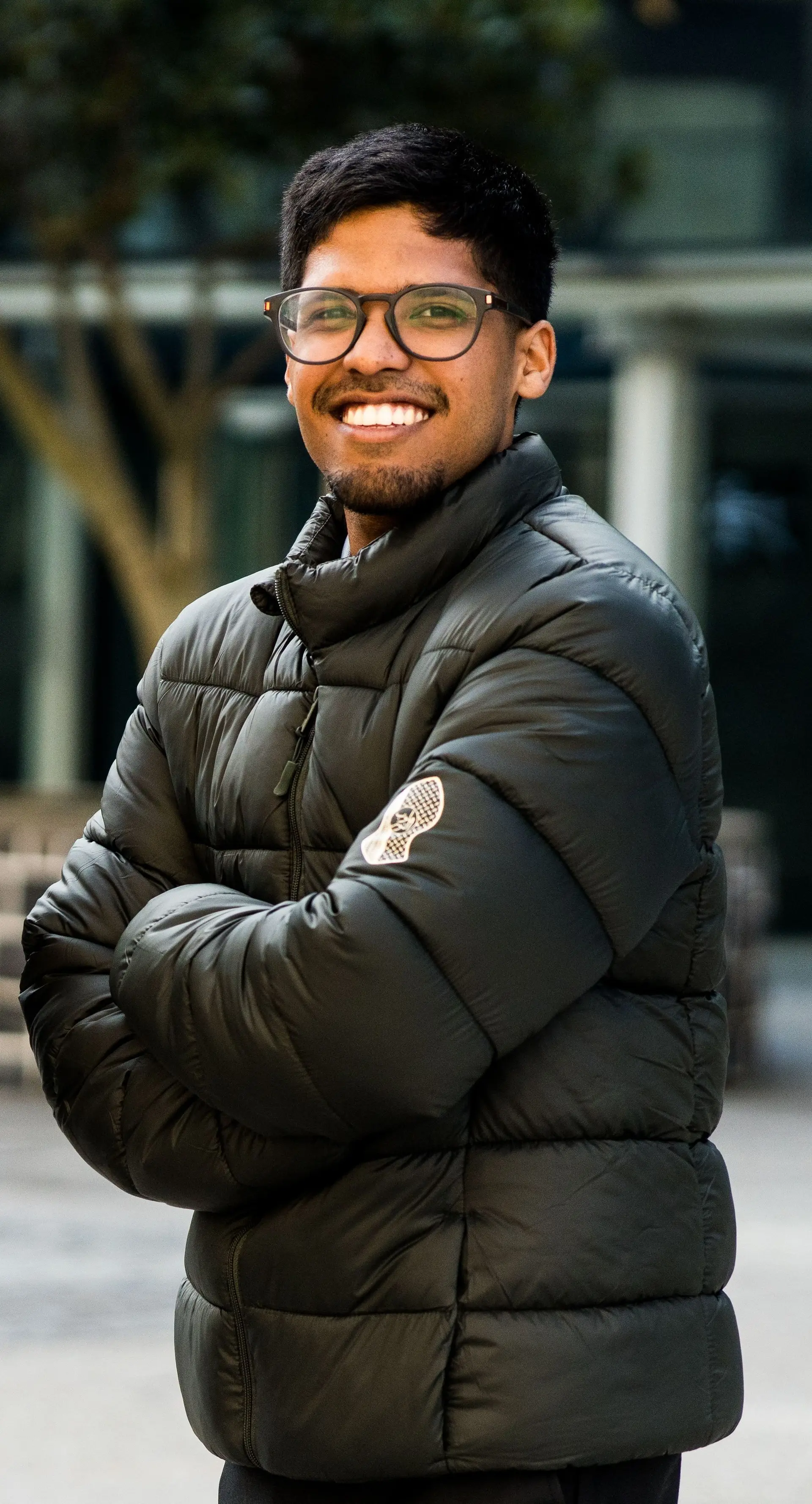 Olive puffer jacket with the logo on the sleeve