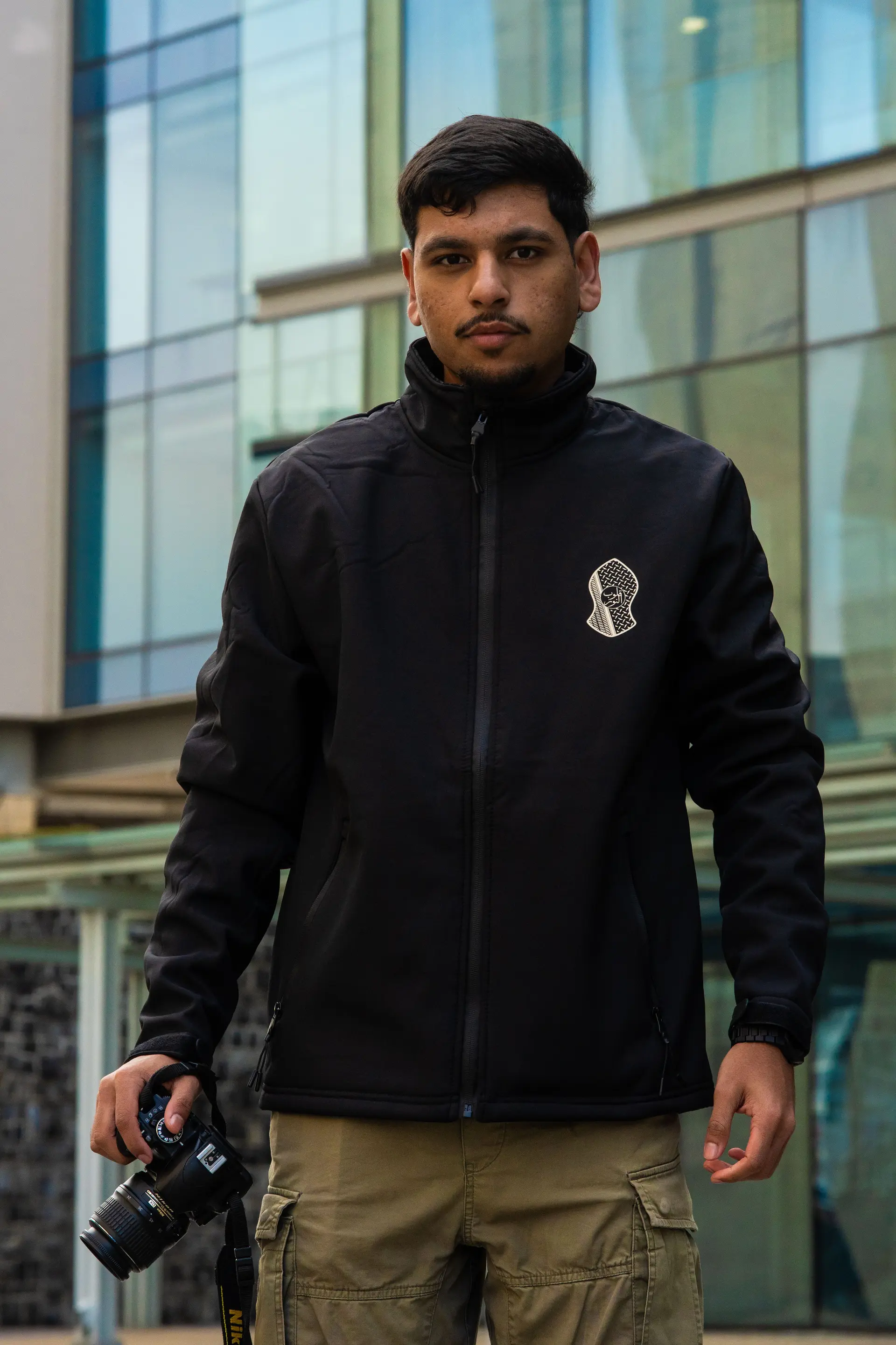 Black soft shell jacket with the logo on the chest